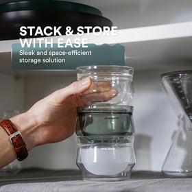 Ovalware stealth-gray glass supports a refined coffee ritual with a steady grip.