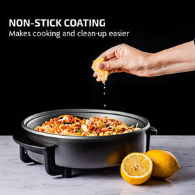 OVENTE electric skillet in action with vegetables for a quick family meal.