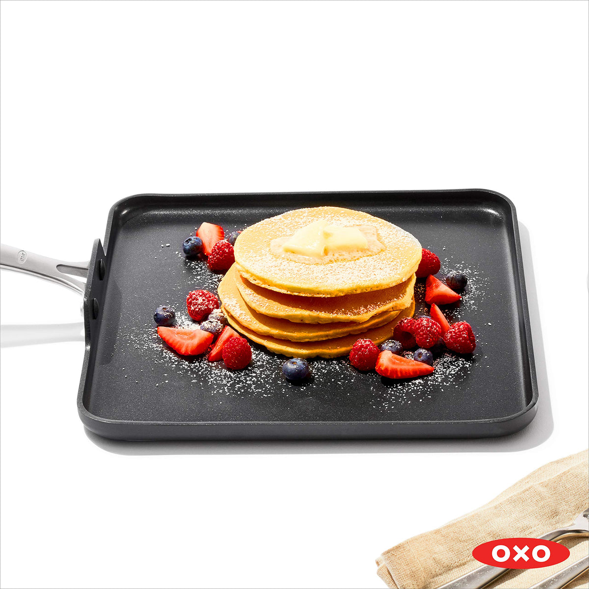 OXO Enhanced 11-inch griddle pan in use, demonstrating even heat and easy cleanup.