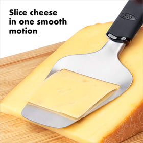 OXO Good Grips Cheese Slicer handle angled for adjustable thickness.