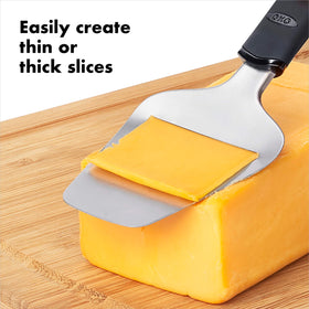 OXO Good Grips Cheese Slicer in action delivering one-smooth-motion slices.