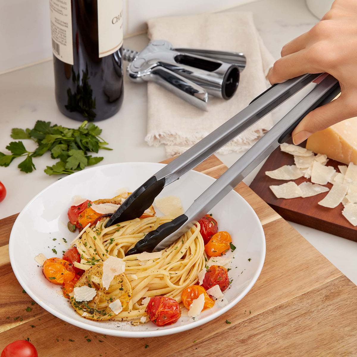 OXO Good Grips 12-Inch Tongs with scalloped edges for secure food handling.
