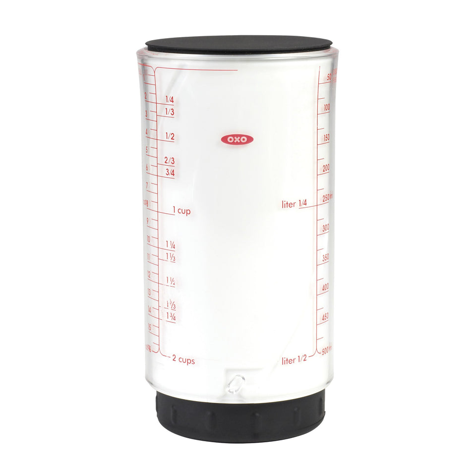 OXO Good Grips 2 Cup adjustable measuring cup front view with smooth plunger for sticky ingredients