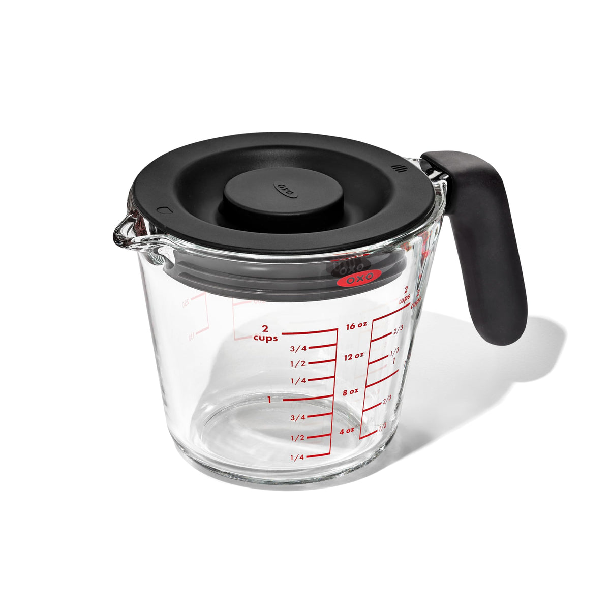 OXO Good Grips 2-Cup Glass Measuring Cup with lid, front view for secure storage and pour control