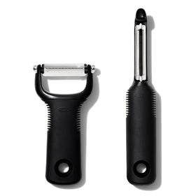 OXO Good Grips 2-Piece Peeler Set in hand with swivel blade, easy peeling.