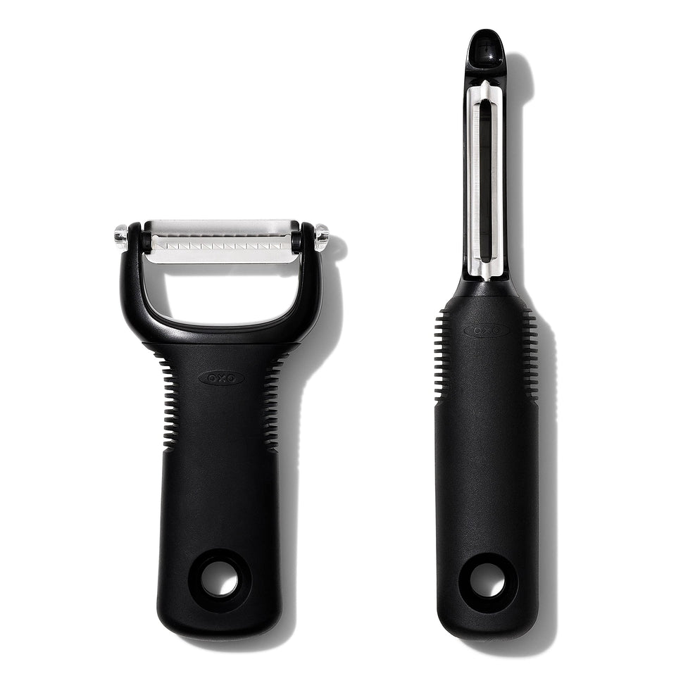 OXO Good Grips 2-Piece Peeler Set in hand with swivel blade, easy peeling.