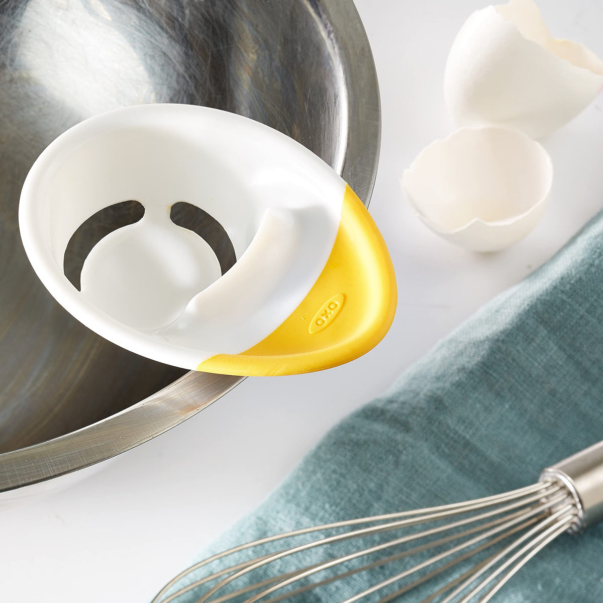 OXO Good Grips egg separator showing shell catcher base catching shells.