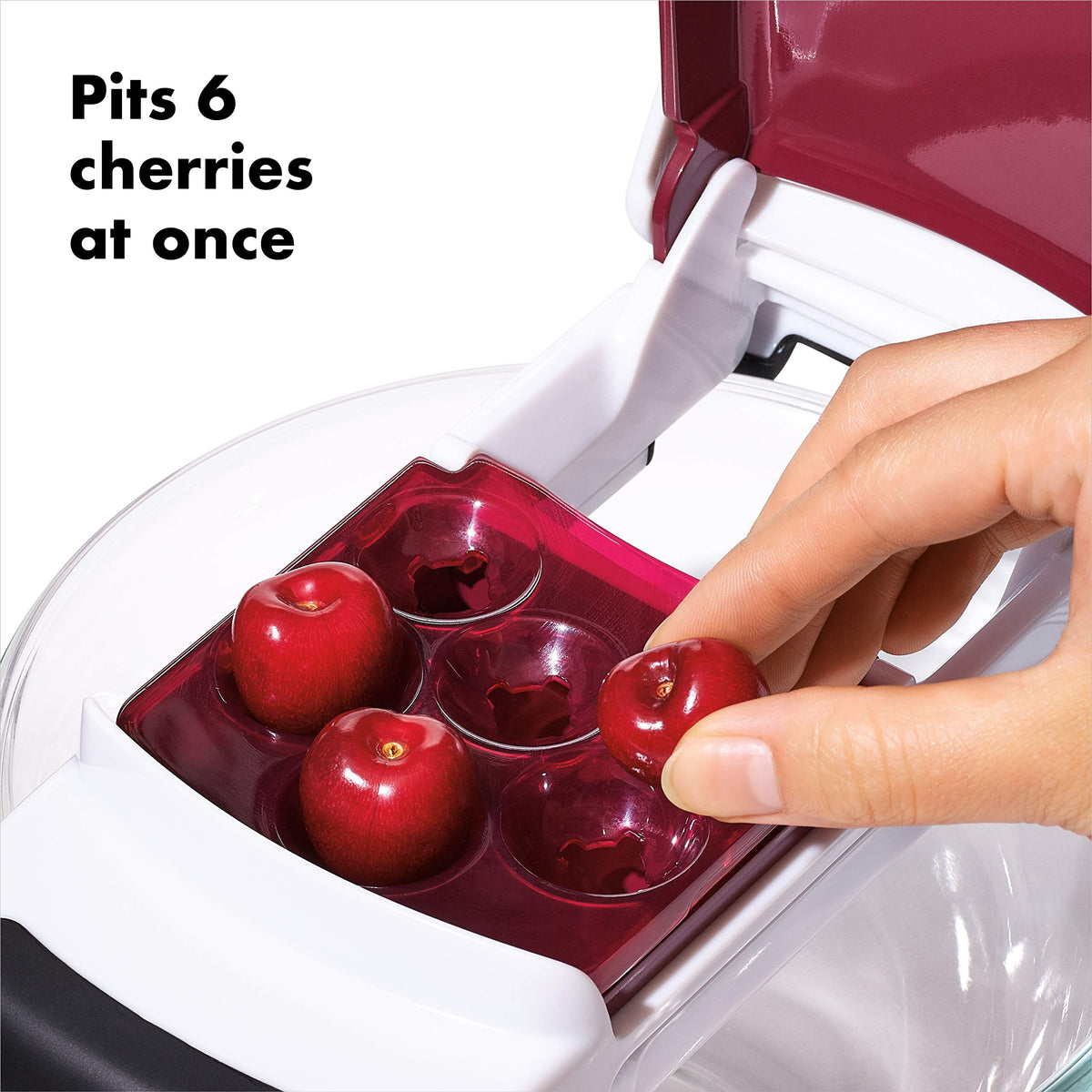 OXO Good Grips cherry pitter catches pits in tray, keeping area tidy