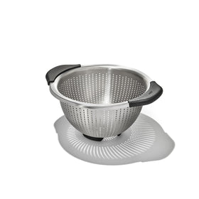 OXO Good Grips colander close-up shows elevated handles for comfortable rinsing