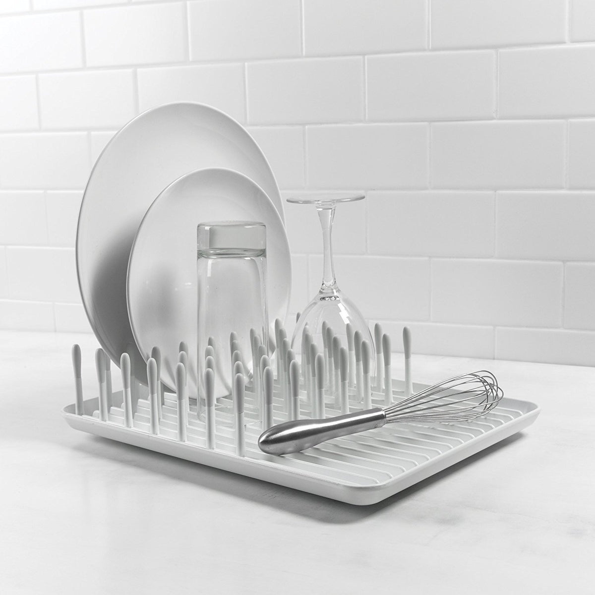 OXO Good Grips Compact Dish Rack biscuit, non-skid feet keep the rack stable.