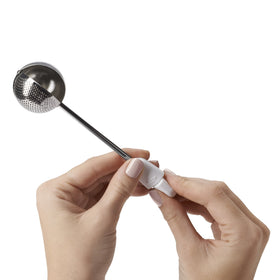 OXO Good Grips dusting wand's solid side rests on the counter.
