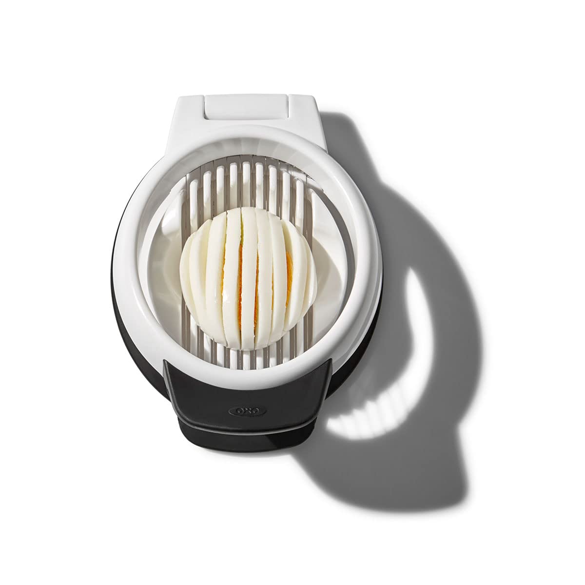 OXO Good Grips Egg Slicer slicing over a bowl for neat collection.