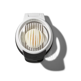 OXO Good Grips Egg Slicer slicing over a bowl for neat collection.