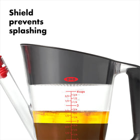 OXO Good Grips fat separator with built-in strainer catches bits for clearer pan juices.
