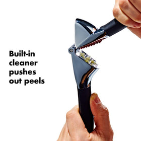 OXO Good Grips Garlic Press with soft, non-slip handles reducing hand fatigue while squeezing.