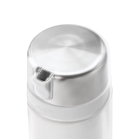 OXO Good Grips sugar dispenser in use on a kitchen counter for easy access.