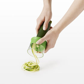 OXO Good Grips spiralizer food holder supports hands and doubles as storage cap.