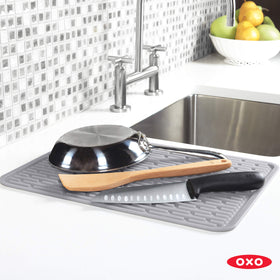 OXO Good Grips Large Silicone Drying Mat rolled for space-saving storage