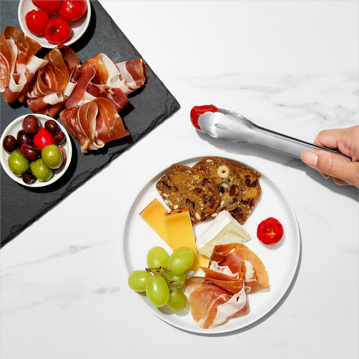 OXO Good Grips mini tongs with scalloped edges secure delicate foods.
