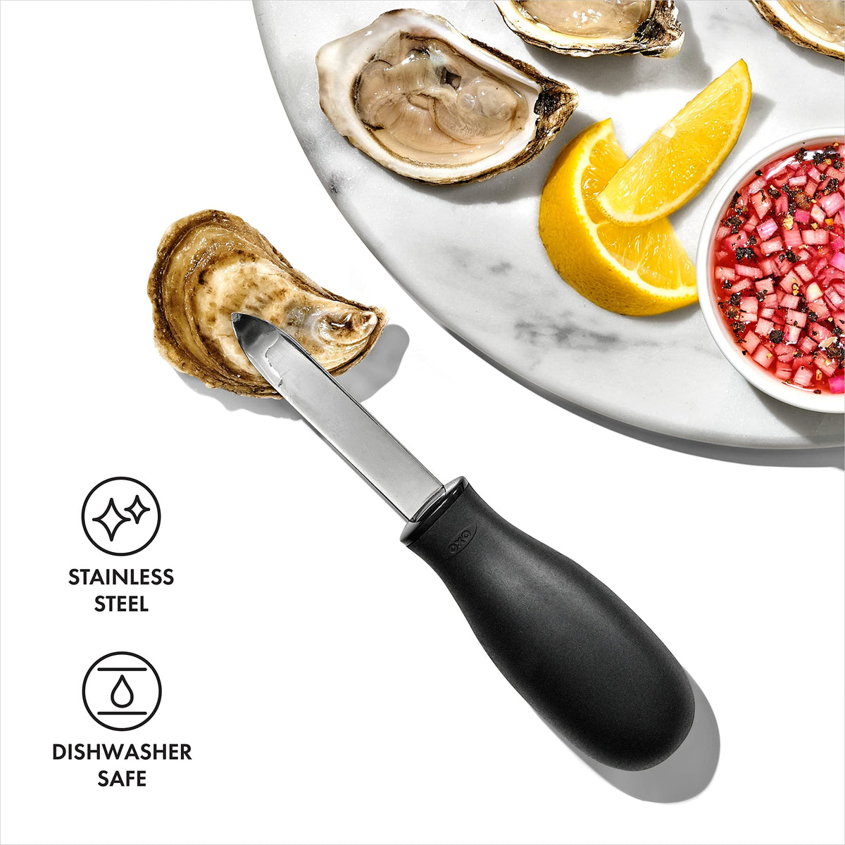 OXO Good Grips oyster knife in use opening fresh oysters.
