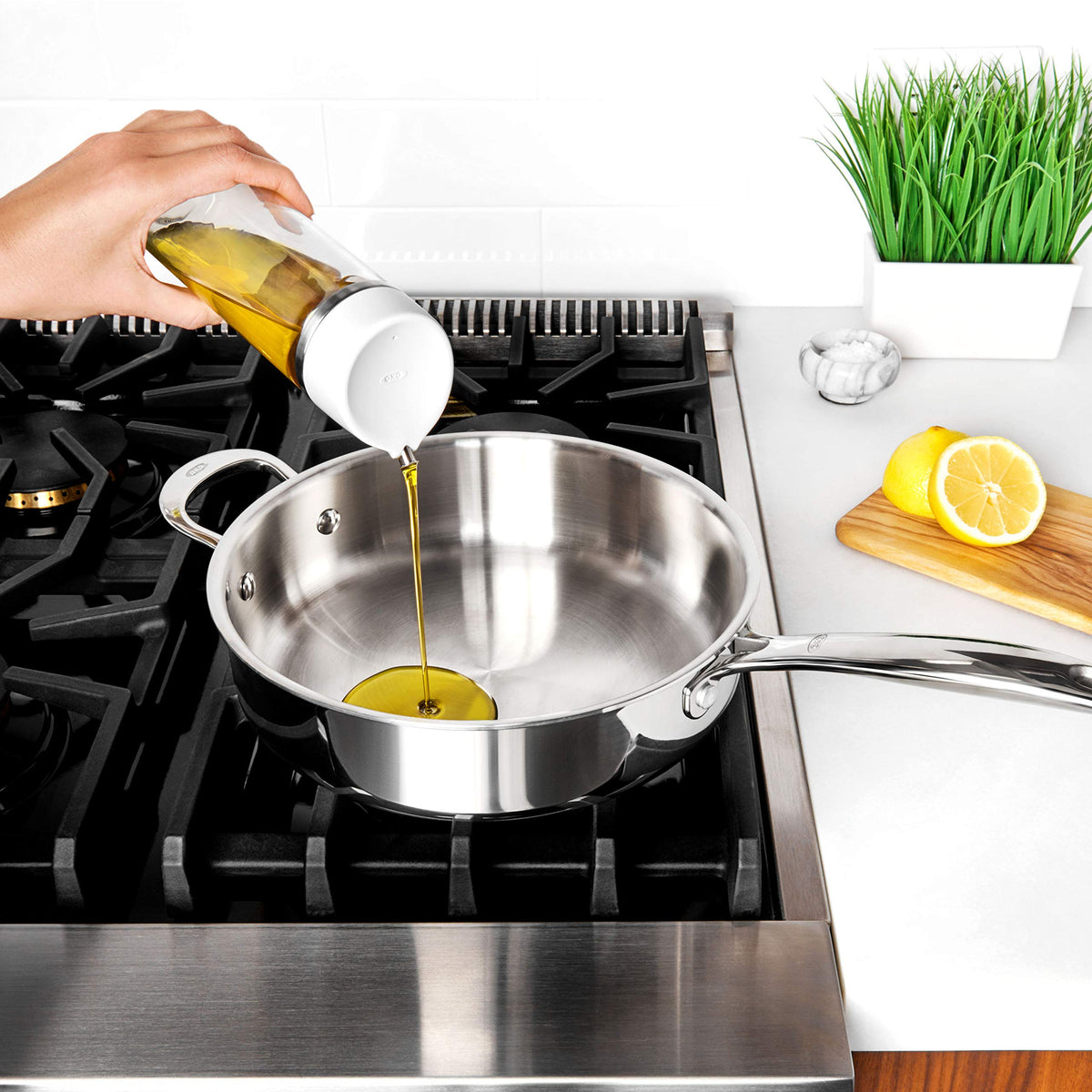 OXO Good Grips on kitchen counter with oil and vinegar.