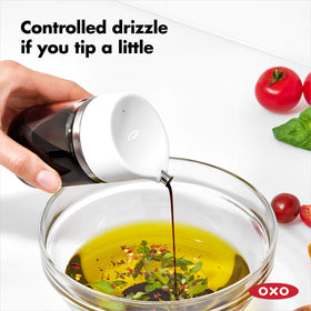 OXO Good Grips Precision Pour Dispenser clear glass body on a kitchen counter