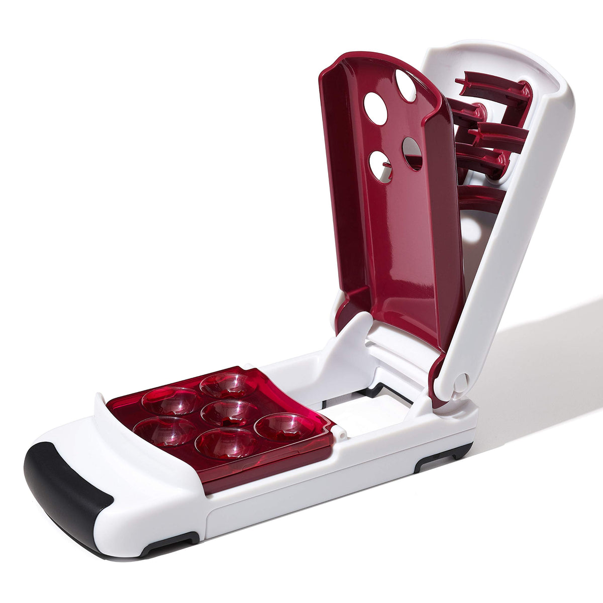 OXO Good Grips Quick Release Multi Cherry Pitter in use, drops pitted cherries into bowl