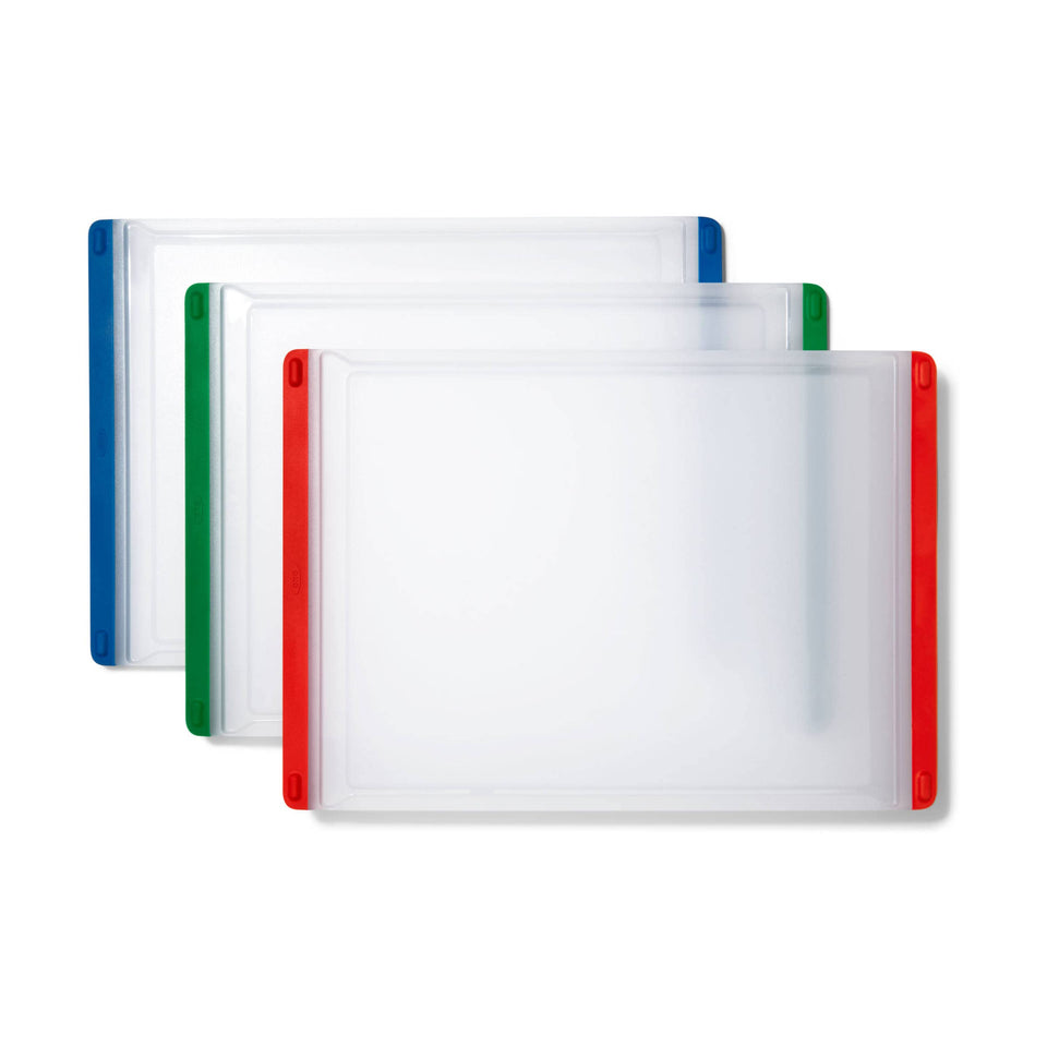 OXO Good Grips red cutting board for meat prep with color coding and easy handling.