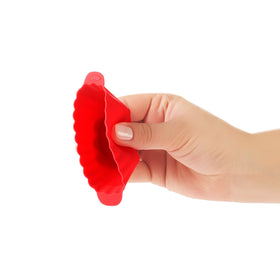 OXO Good Grips silicone baking cups placed on sheet or muffin tin for versatility.