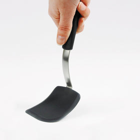 OXO Good Grips silicone cookie spatula lifting cookies from a crowded sheet.