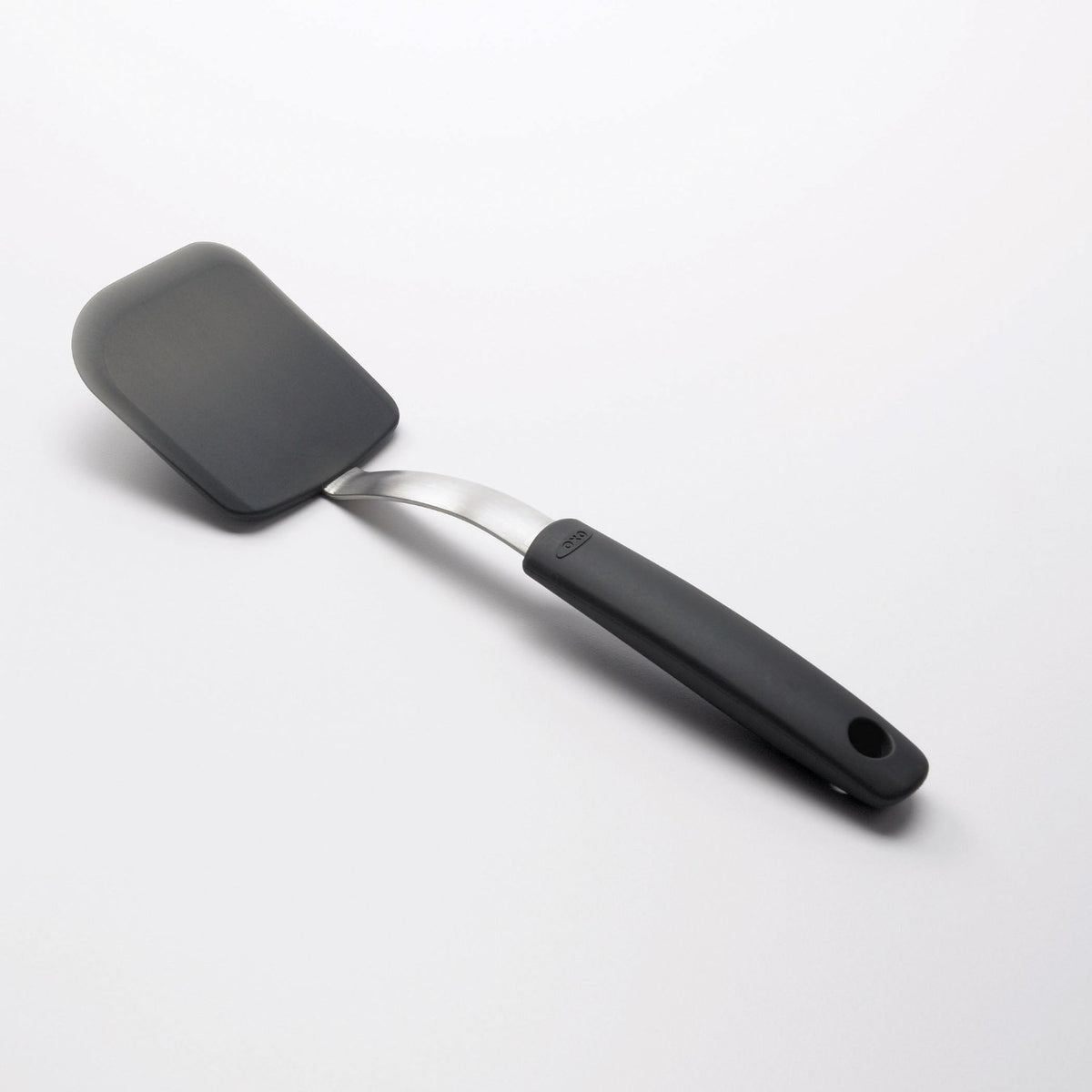 OXO Good Grips silicone cookie spatula angled handle keeps hands away from hot foods.