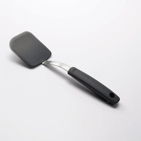 OXO Good Grips silicone cookie spatula angled handle keeps hands away from hot foods.