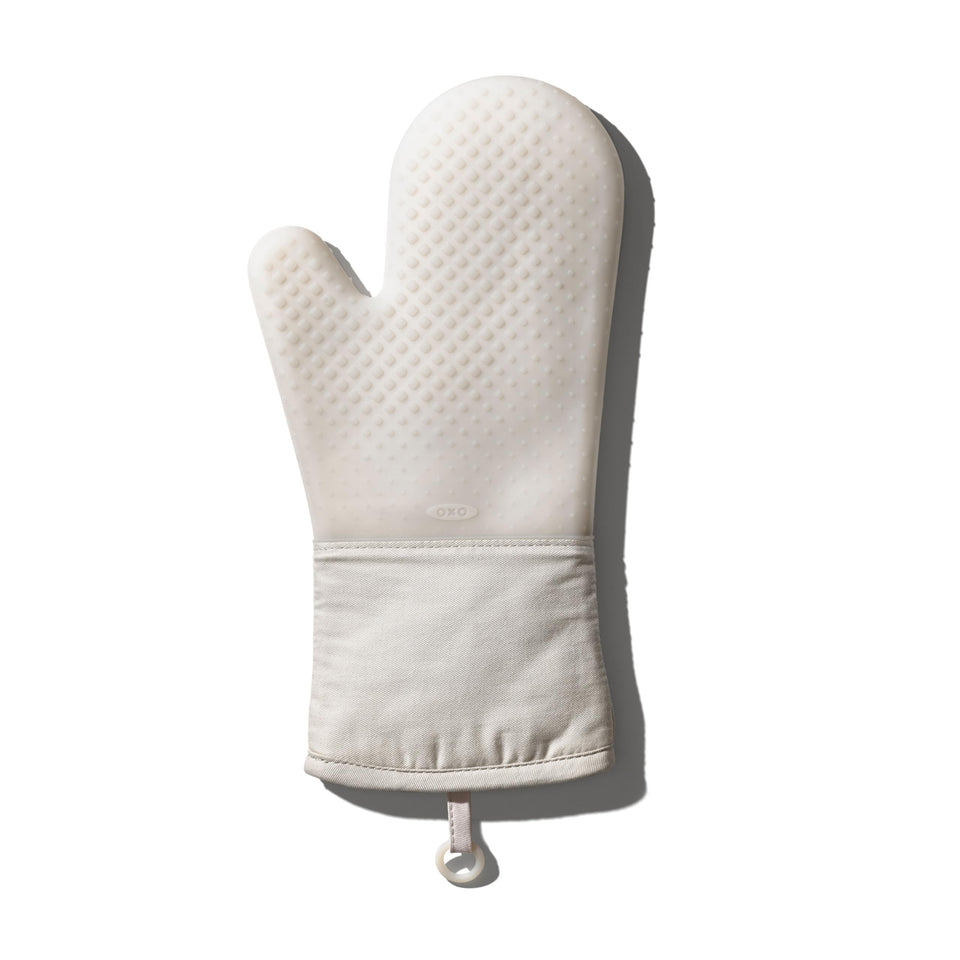 OXO Good Grips silicone oven mitt in oat, closeup of heat-dissipating diamond pattern.