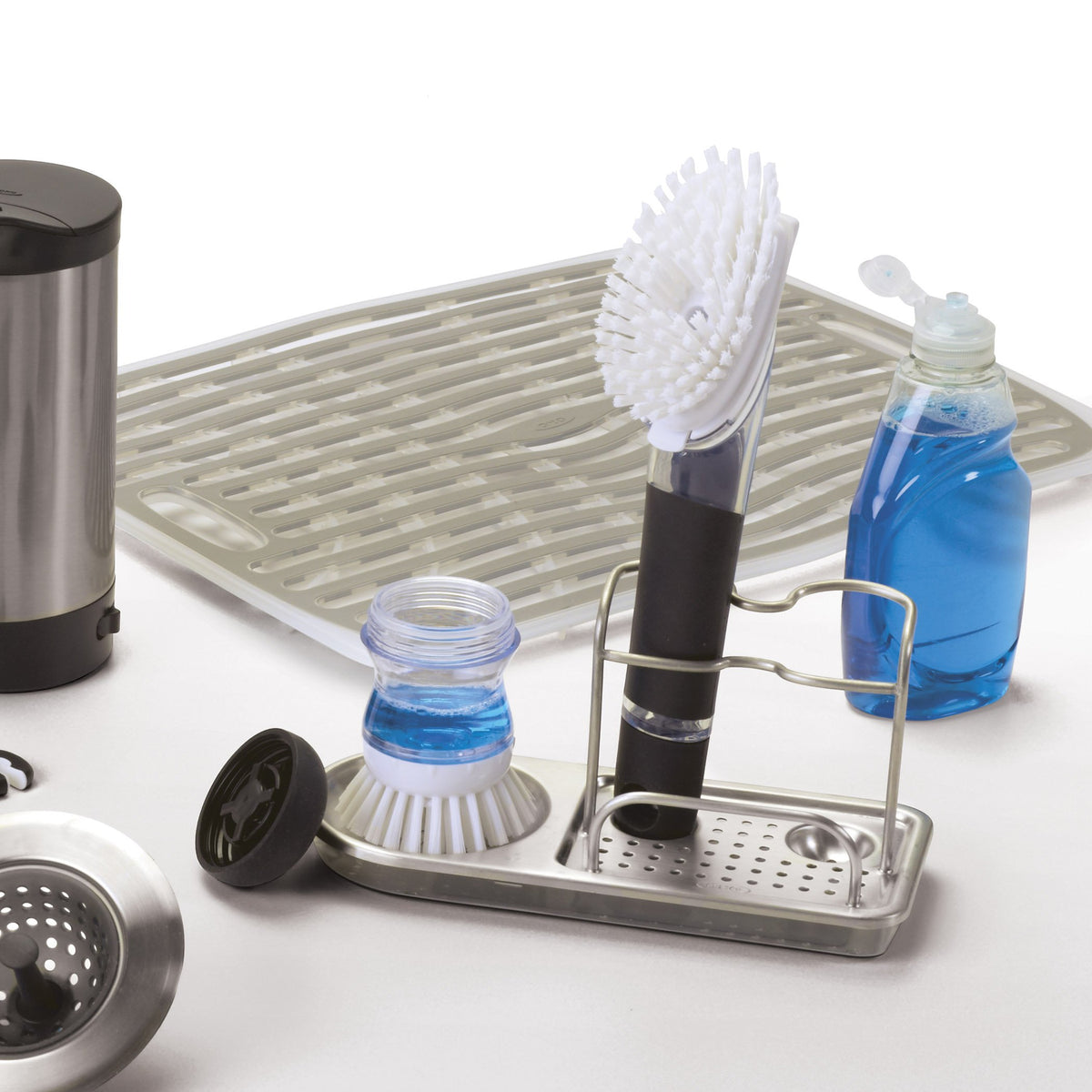 OXO Good Grips sink caddy demonstrates upright storage for long-handled tools for easy access.