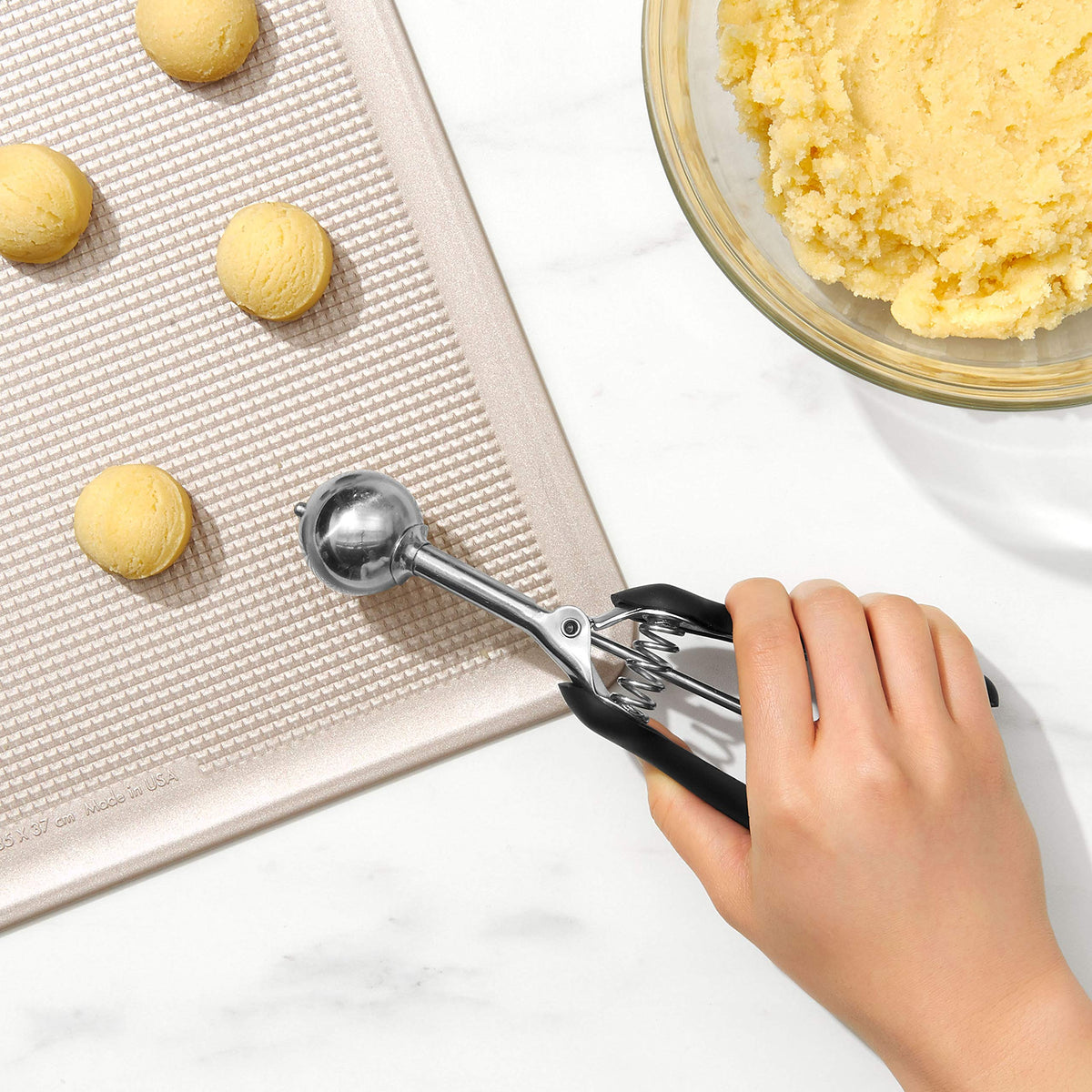 OXO Good Grips small cookie scoop ergonomic handle close-up.