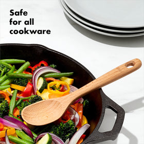 OXO Good Grips slotted wooden spoon showing drainage while cooking.