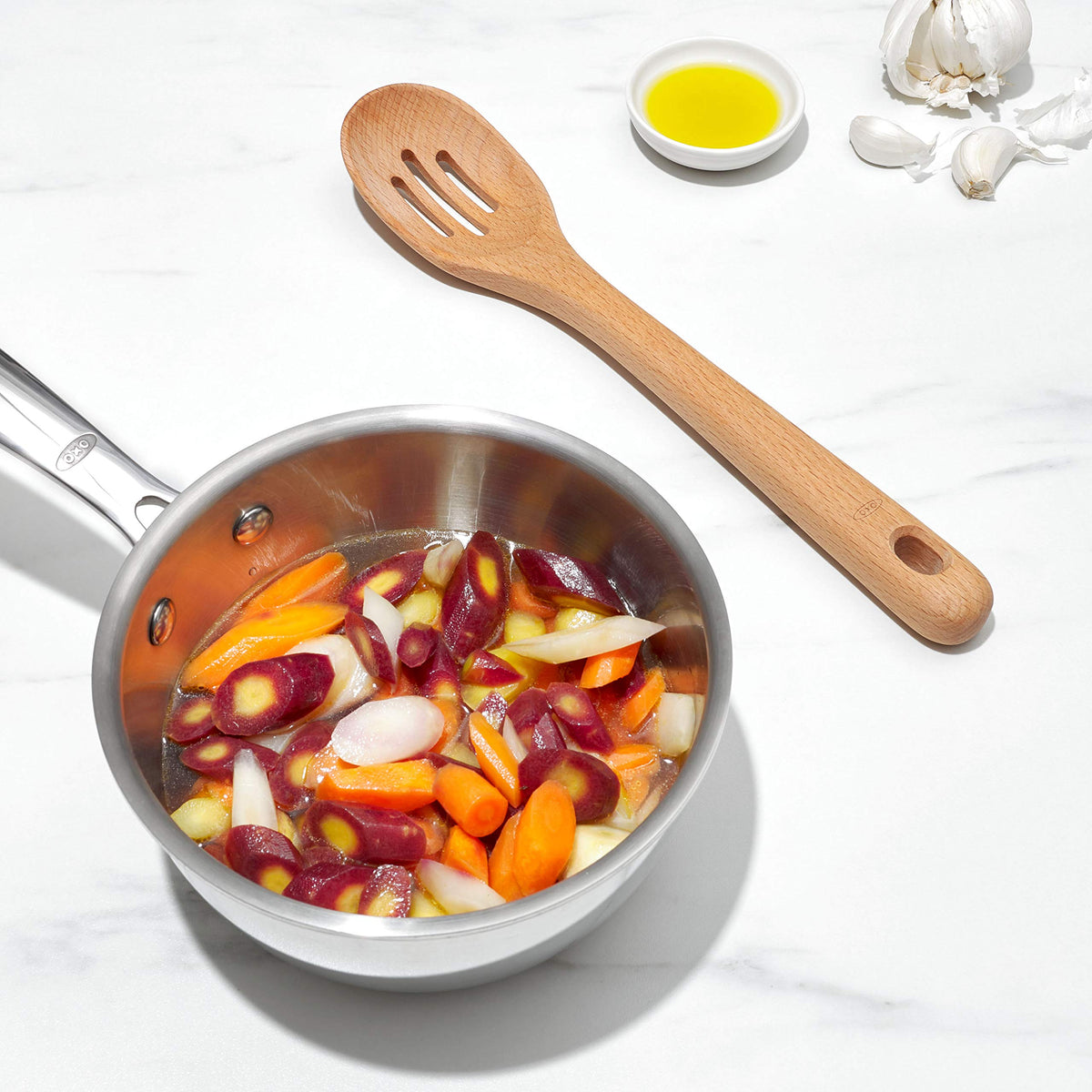 Large ergonomic handle on OXO Good Grips wooden utensils.