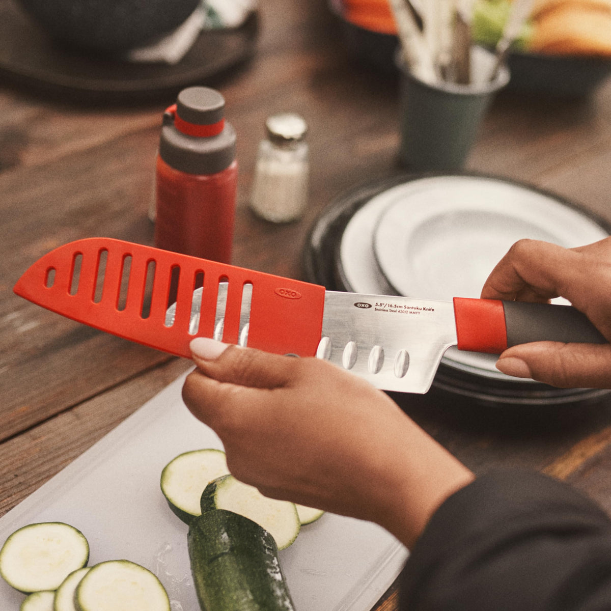 OXO Outdoor Santoku Knife being washed and dried after use.