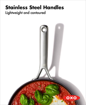 Stainless steel handle on the OXO pan offers a secure grip during cooking.