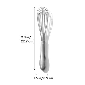 OXO SteeL whisk in brushed stainless steel beside a mixing bowl.