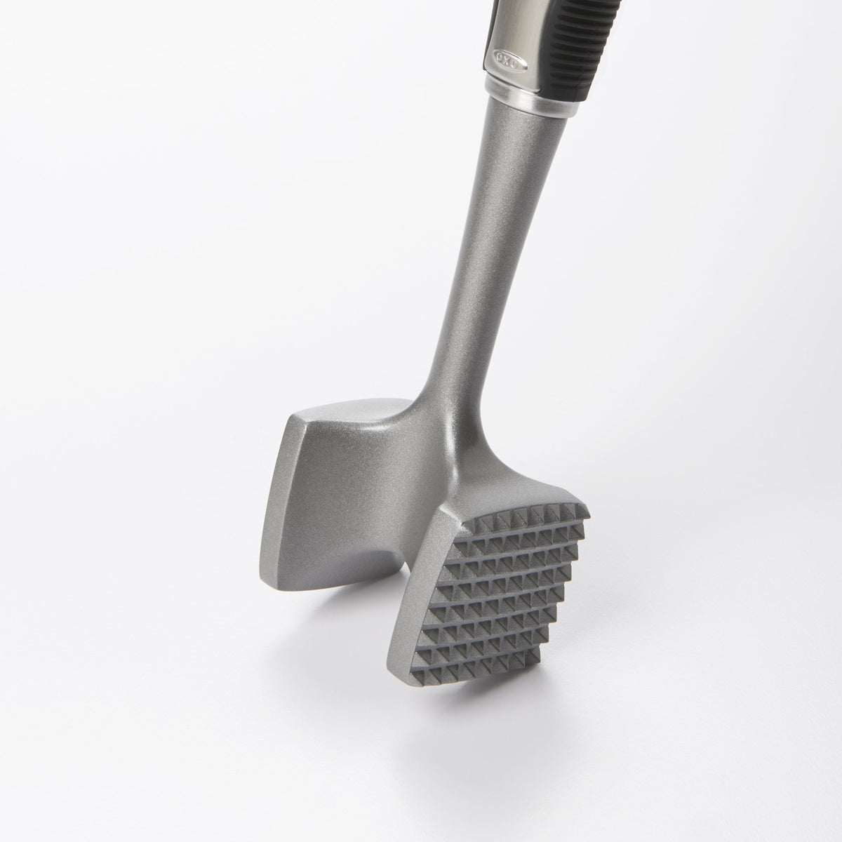Close-up of OXO SteeL tenderizer pounding plate in action for even results
