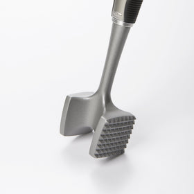 Close-up of OXO SteeL tenderizer pounding plate in action for even results