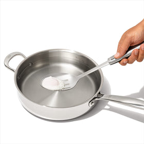 OXO Steel Slotted Spoon stirring a simmering soup