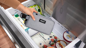PackIt Freezable Snack Box Gray Fog clipped to a tote for hands-free portability
