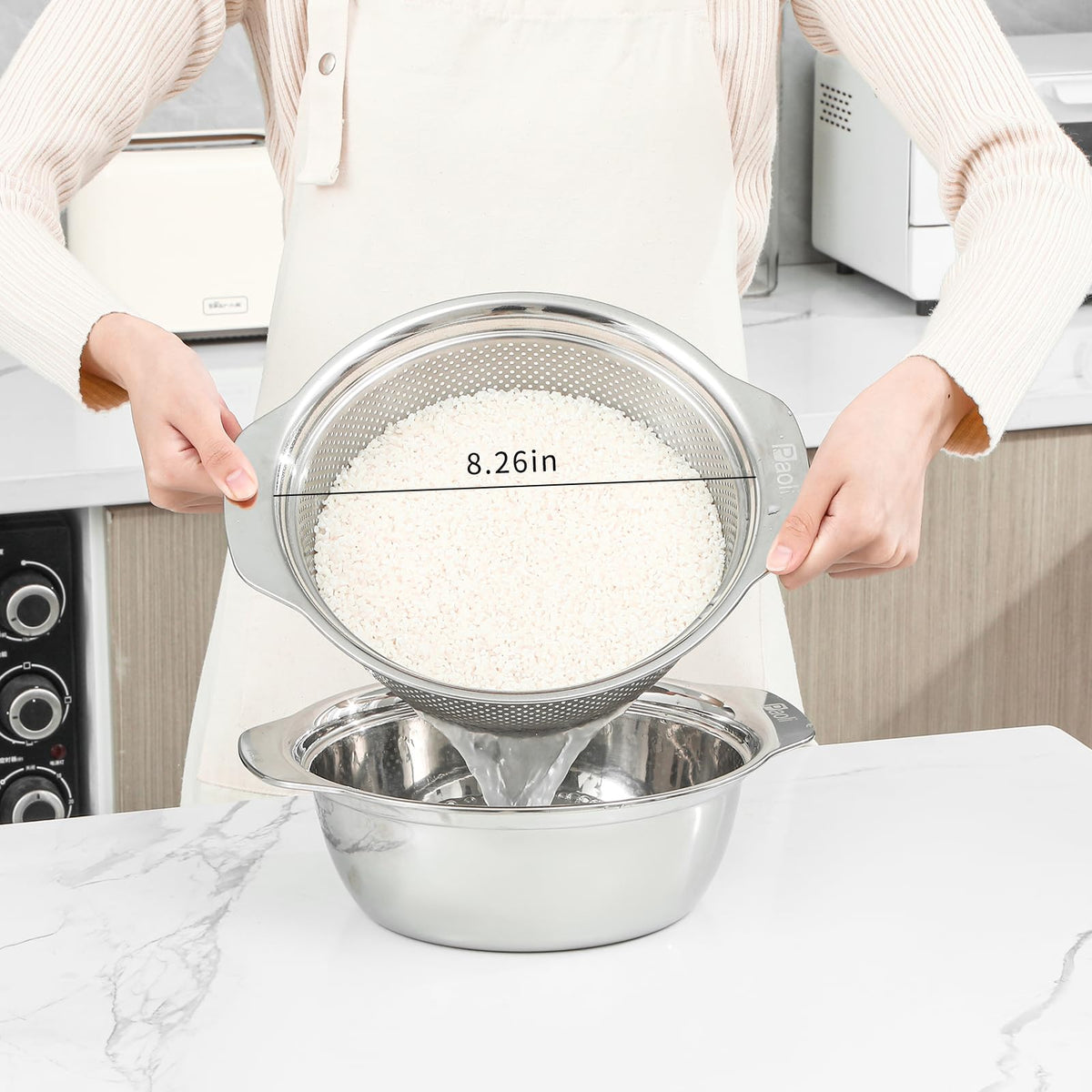 Paoli colander with handle side view, durable mirror finish for easy cleaning.