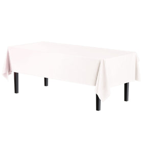 Party Solids Exquisite 6-pack tablecloth 54x108 on a dining table, pristine white