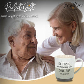 Pavilion Retirement Mug held in hand highlighting ergonomic grip.