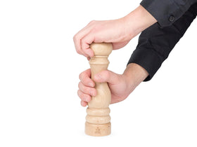 Peugeot Paris u-select pepper mill close-up, showing wood grain and steel mechanism.