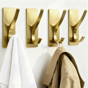 Pickpiff brushed gold self-adhesive coat hook holding towels in a bathroom