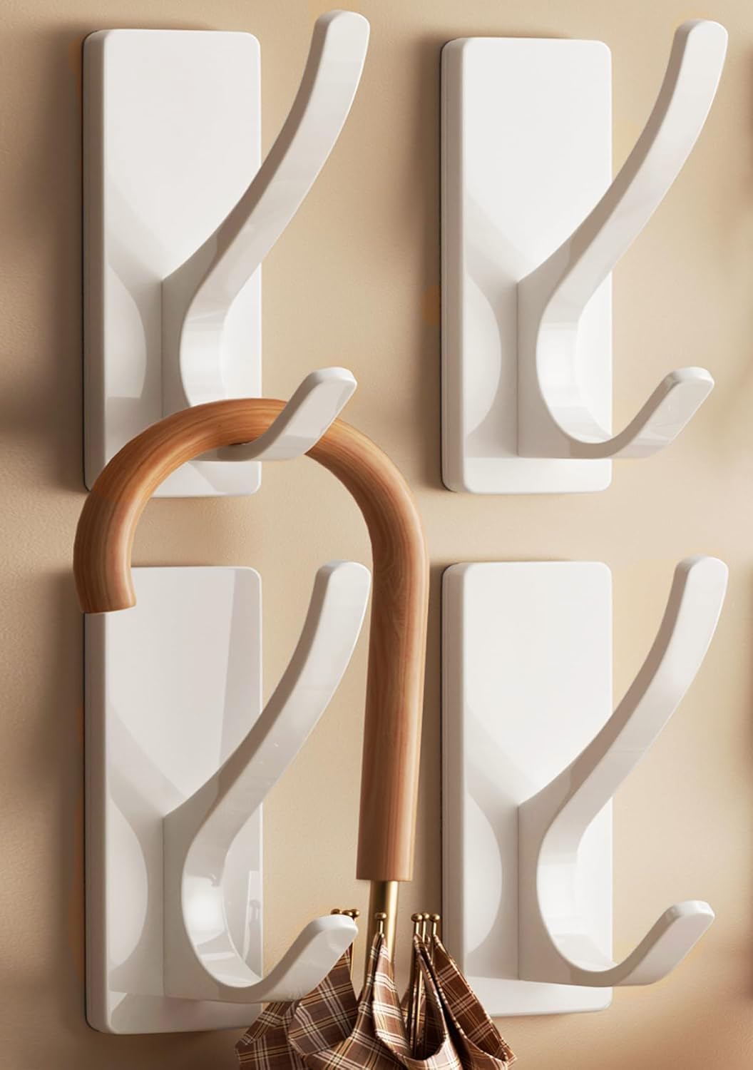 Pickpiff white coat hook with adhesive base blends into walls for clutter-free spaces